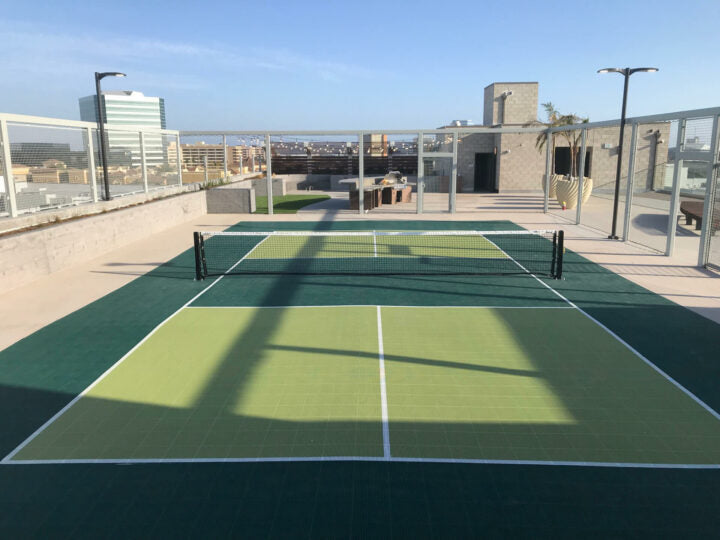 30'x60' modular pickleball court featuring dark and light green game court colors