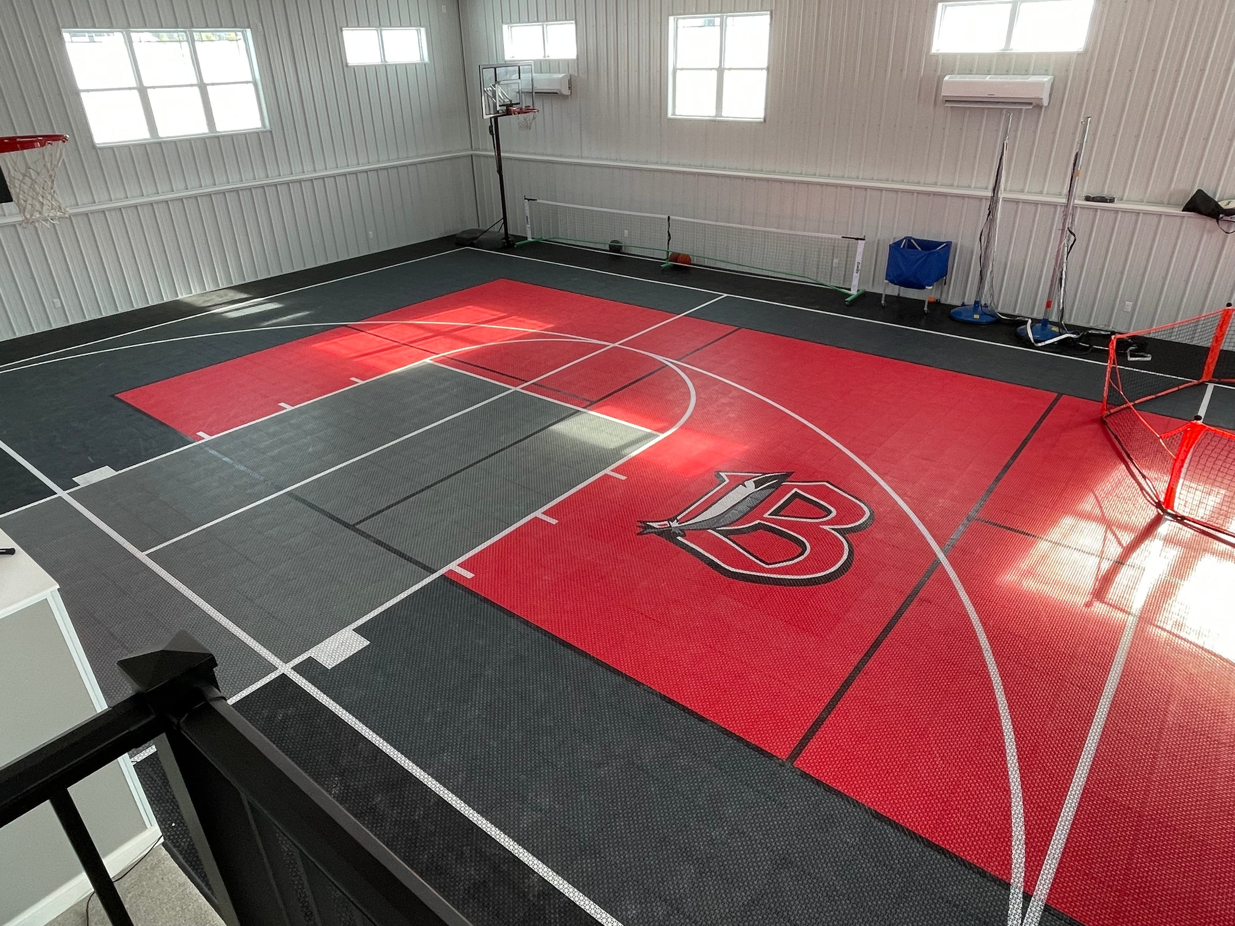 Indoor custom multi-game modular court with half-court basketball and pickleball court. 