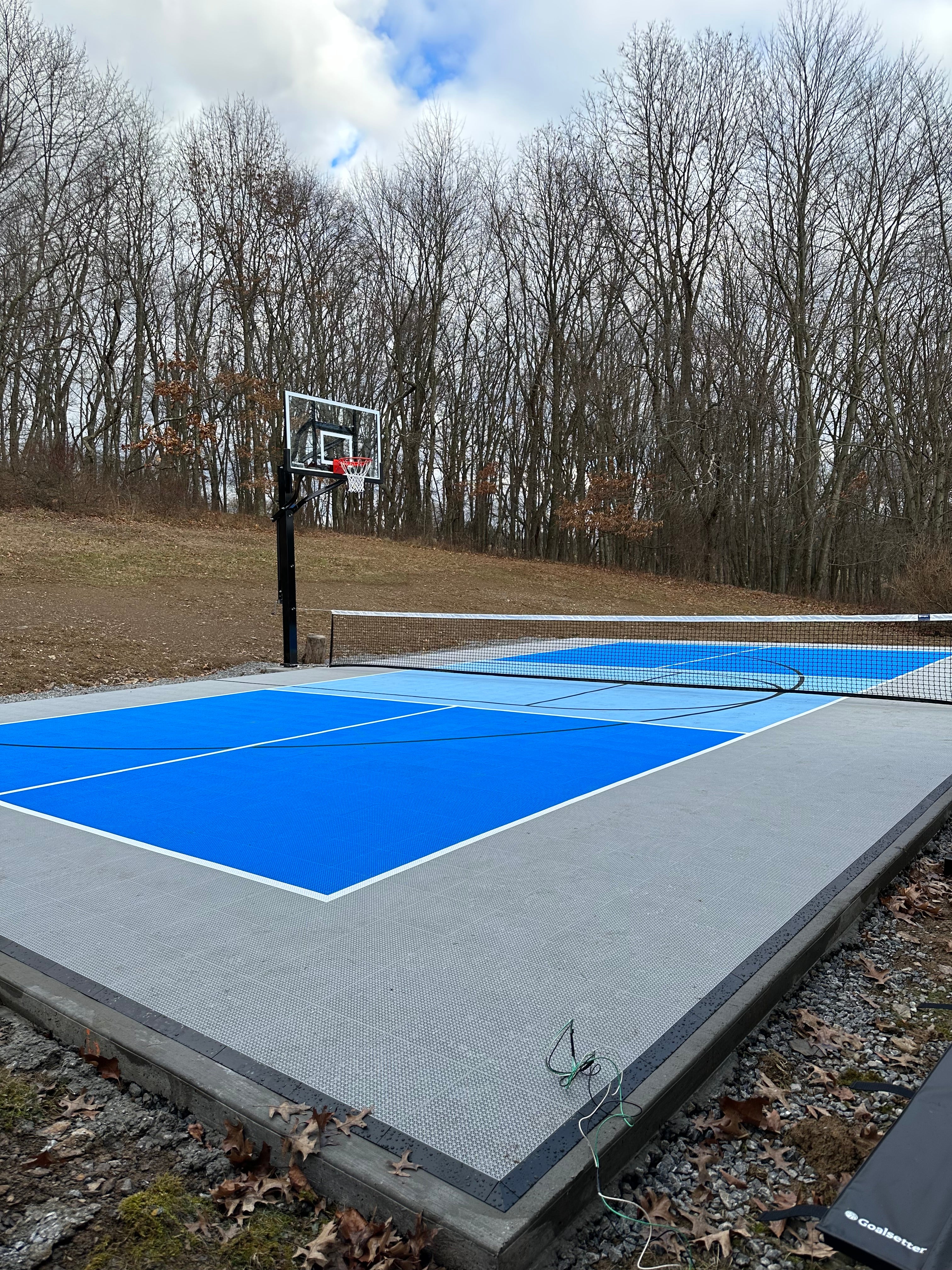 Custom backyard modular multi-game court with half basketball and pickleball 