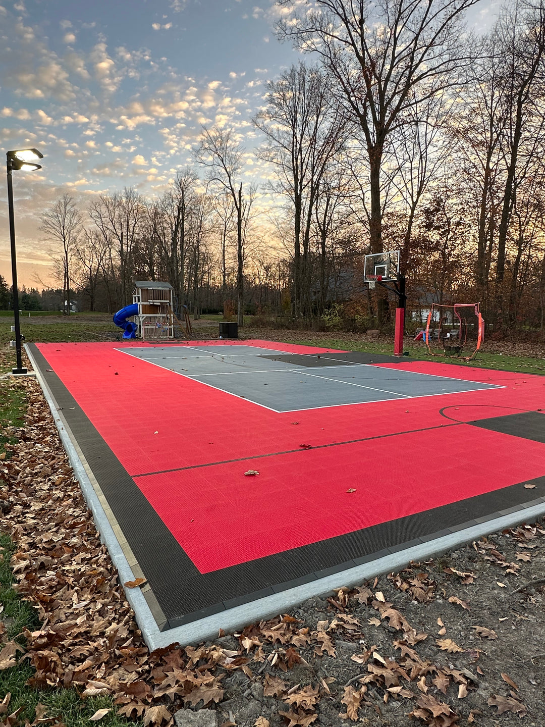 Modular multi-game tile court featuring backyard basketball and pickleball. 