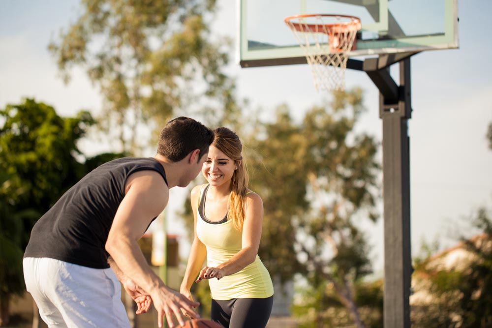 Man and woman playing basketball